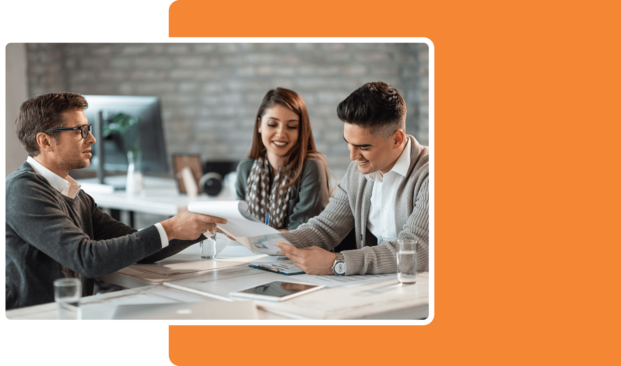 Person in a suit holding a model of a house